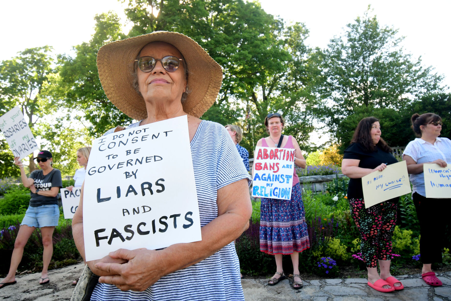 A woman holds up a sign